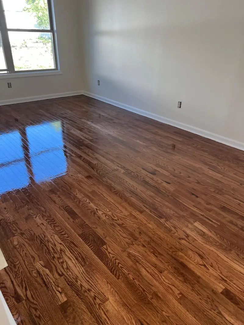 Close view of a refinished hardwood floor with a mirror-like gloss finish